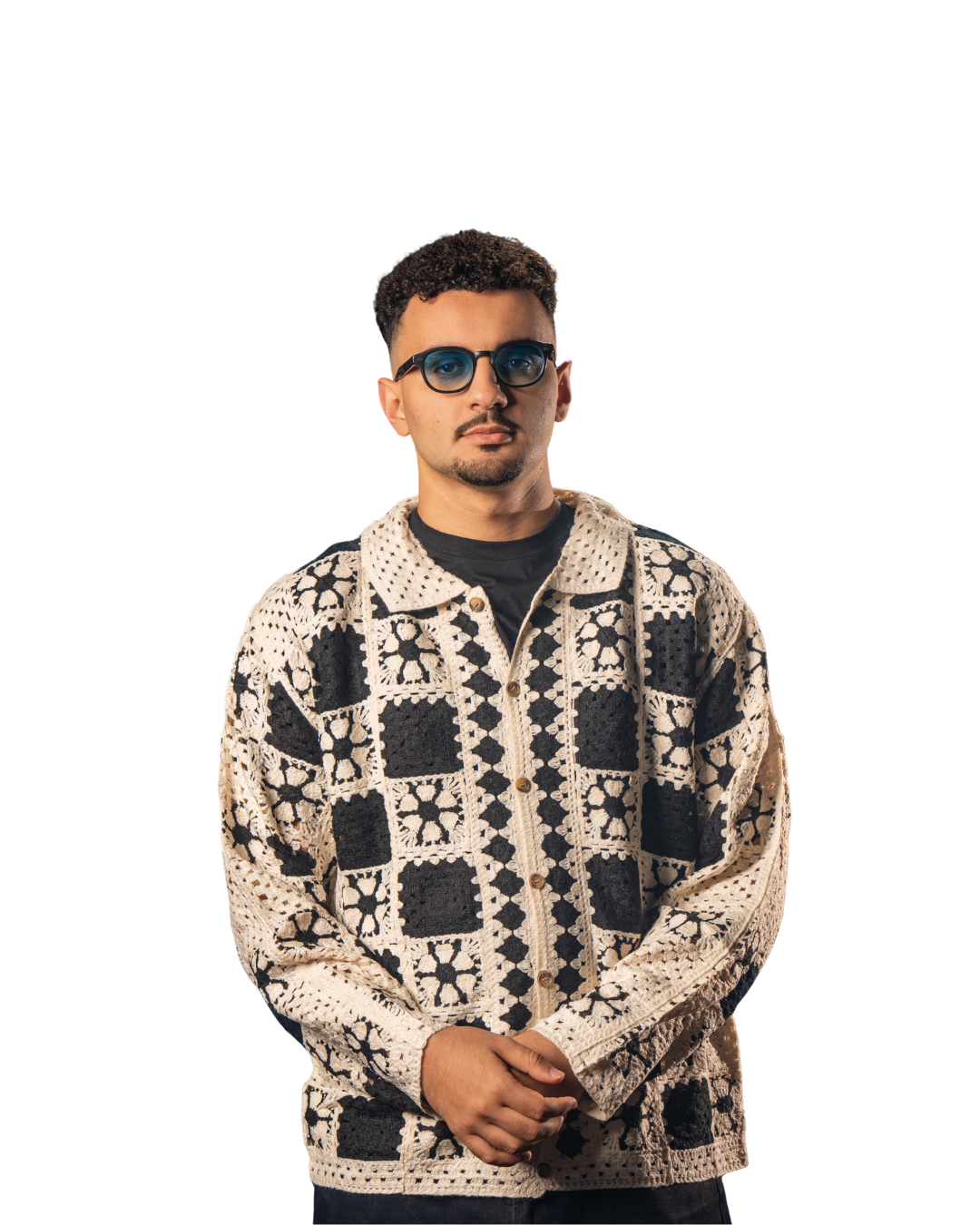 a man wearing a sweater and sunglasses